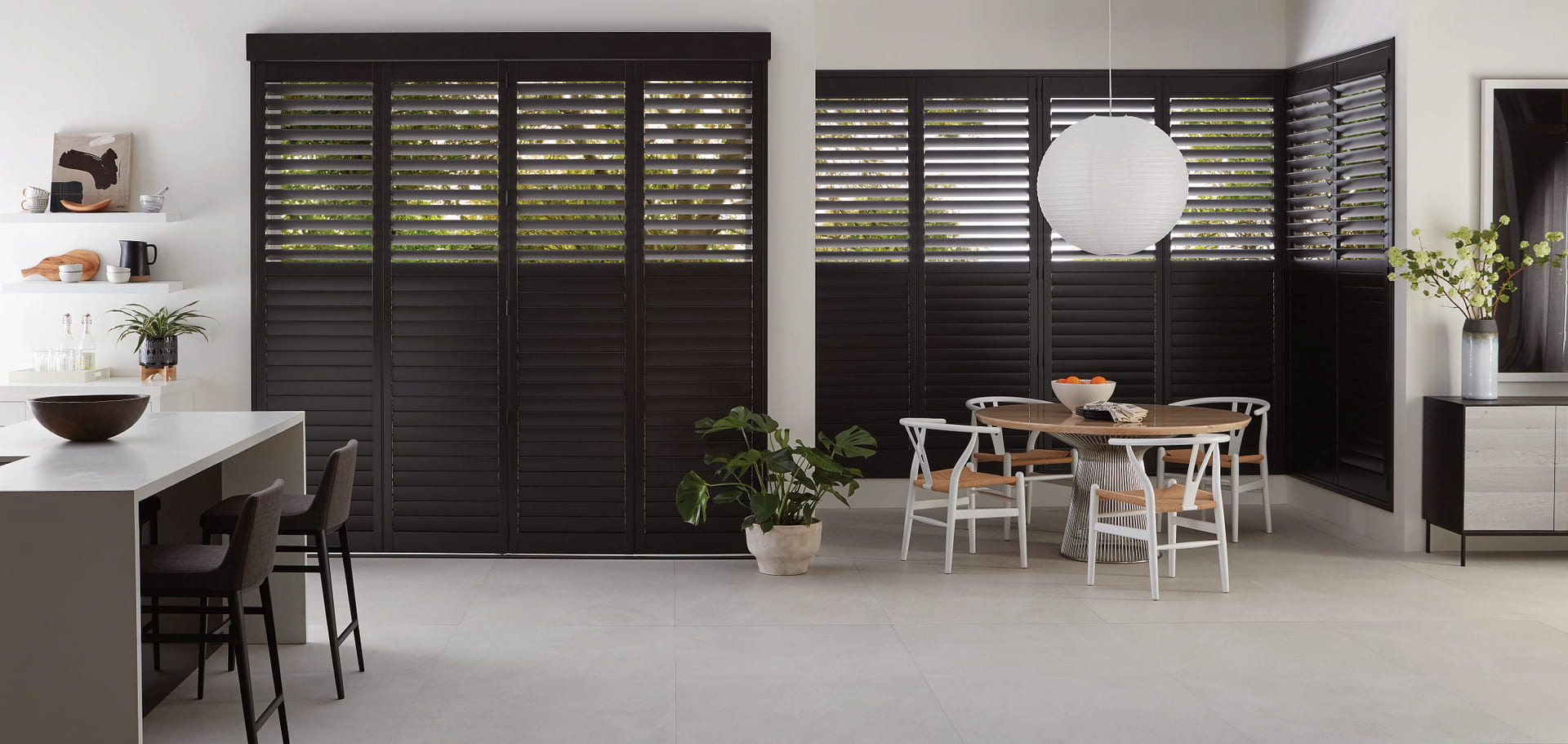 Modern kitchen and dining room with striking black shutters